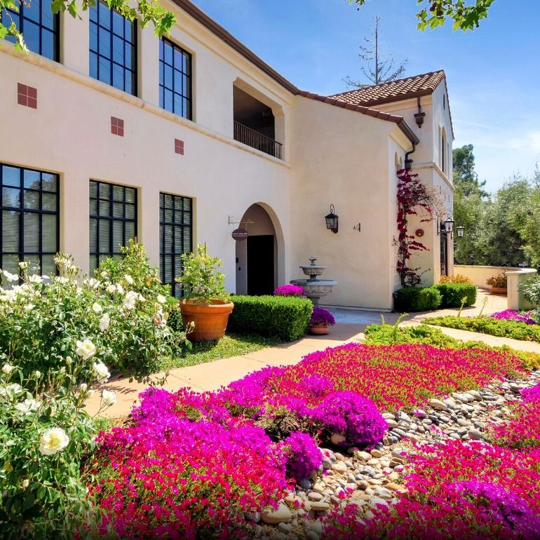 Colorful flowers in front of a beautiful building.