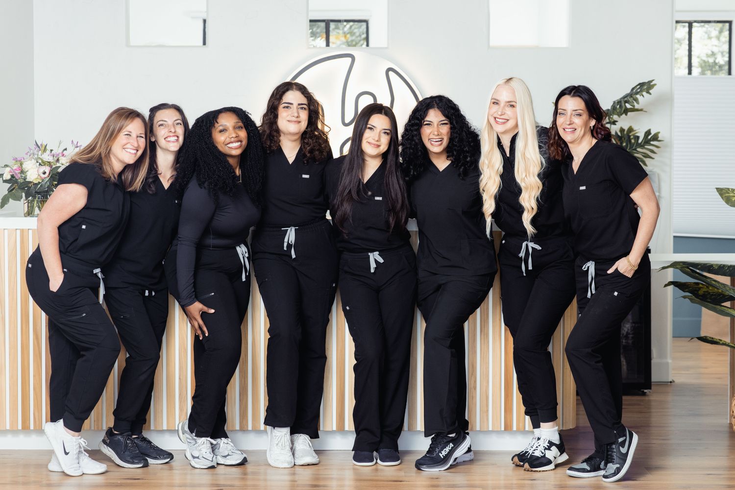 Smiling healthcare professional in green scrubs.