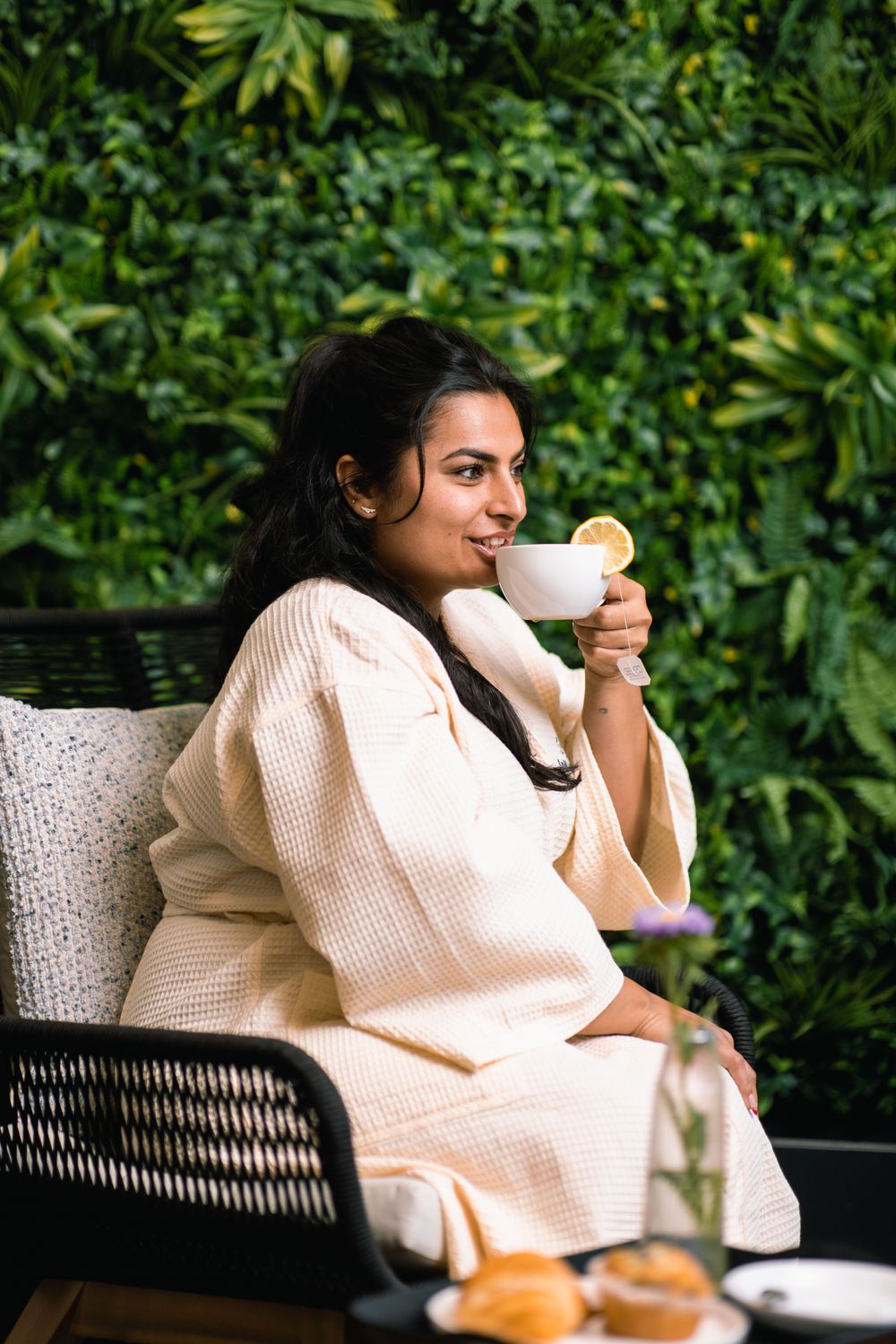 Woman enjoying morning coffee in bed.